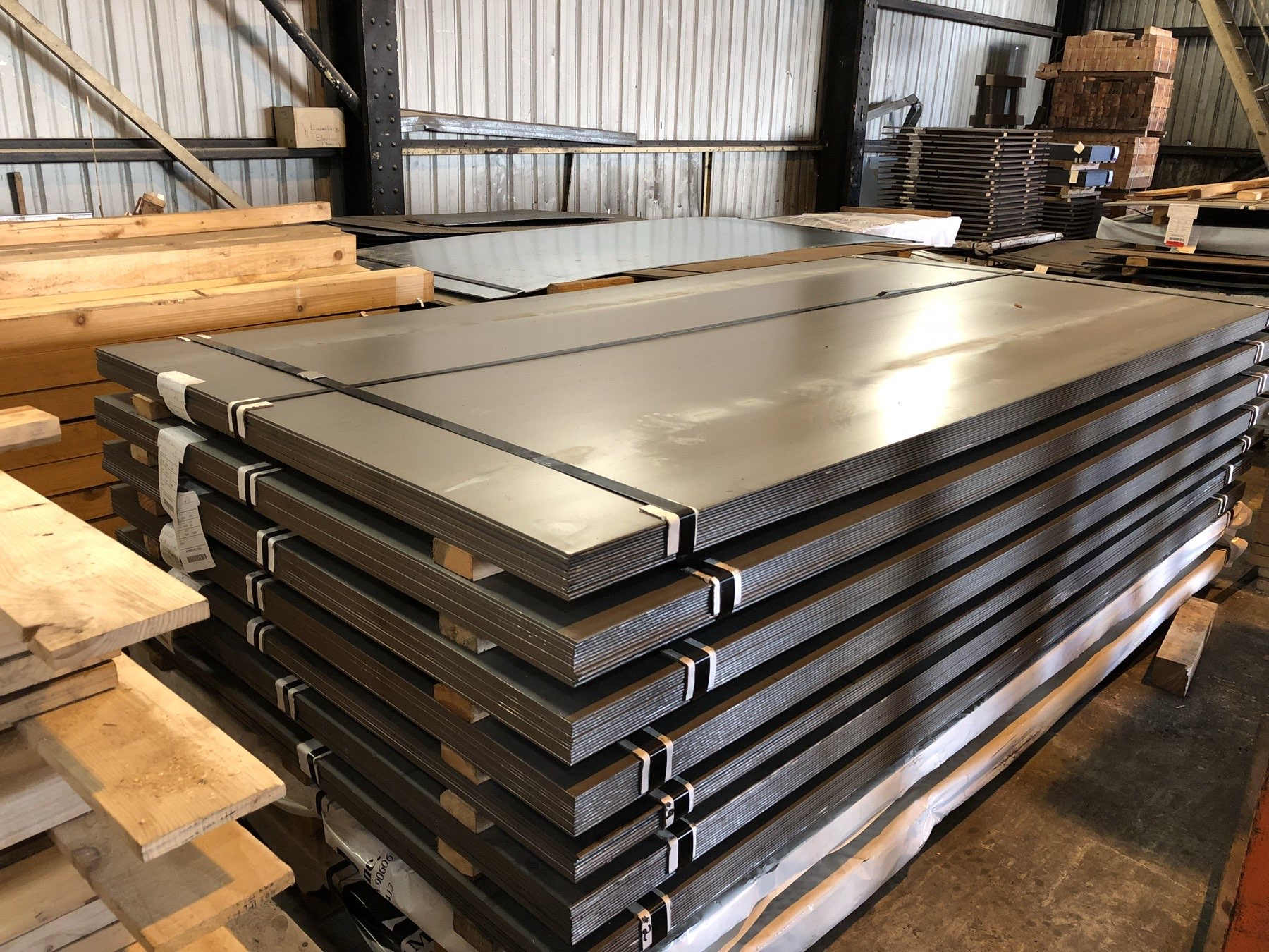Stacked sheared steel plate bundles in the Esserman warehouse